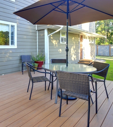 Brown composite deck with outdoor patio set