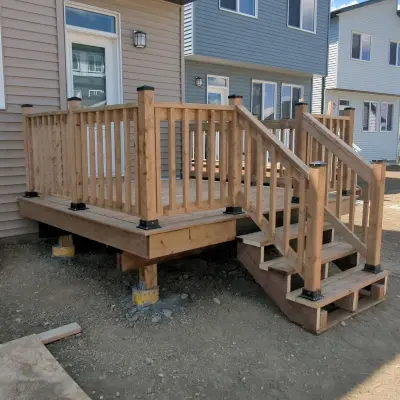 Pressure treated deck with handrail and steps in Edmonton built by Kites Construction