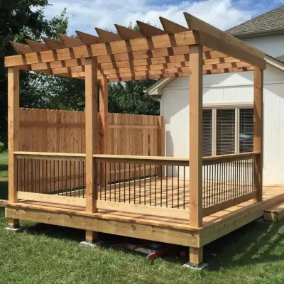 Pressure-treated deck with pergola and safety handrail with metal pickets – a strong and stylish backyard upgrade.