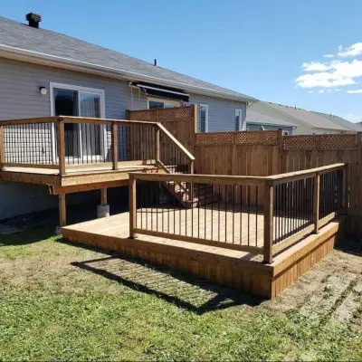 Two-story pressure treated deck with handrail and connecting stairs