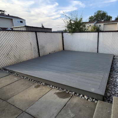 Grey balcony composite deck with black metal handrail